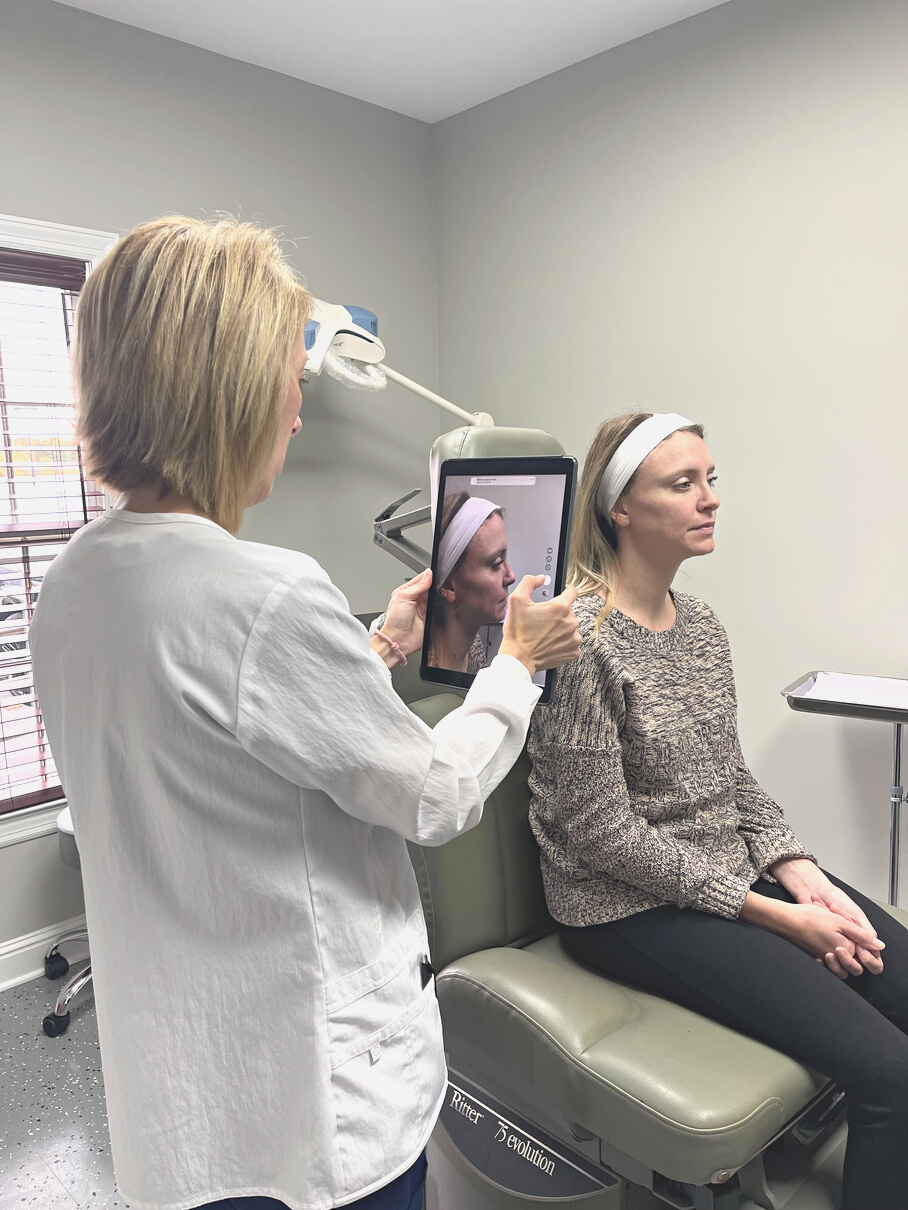 Dr. Messick-Hite using a tablet for examination